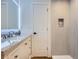 Contemporary bathroom features a large vanity with granite counters, a door, and tiled shower with niche at 35 Everett St, Lakewood, CO 80226