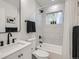 Modern bathroom with white tile, black fixtures, and a shower-tub combination at 35 Everett St, Lakewood, CO 80226