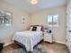 Bright bedroom with a cozy bed, fresh decor, and natural lighting at 35 Everett St, Lakewood, CO 80226