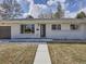 Charming single-story home with a well-manicured lawn and inviting front entrance and large windows at 35 Everett St, Lakewood, CO 80226