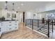 Hallway showcasing modern railing, white trim, and an open floor plan at 35 Everett St, Lakewood, CO 80226