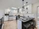 Modern kitchen with stainless steel appliances, white cabinets, and a granite countertop island with seating at 35 Everett St, Lakewood, CO 80226