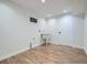 Bright laundry room featuring a utility sink, fresh white paint and luxury vinyl plank flooring at 35 Everett St, Lakewood, CO 80226