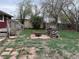 An outdoor space featuring a fire pit, stacked firewood, and a partially fenced yard at 1985 Blackhawk St, Aurora, CO 80011