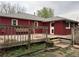 Backyard view of the wood deck and faded brick exterior of the home at 1985 Blackhawk St, Aurora, CO 80011