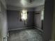 Bedroom featuring carpeted floors, plain lavender walls, and outdated decor at 1985 Blackhawk St, Aurora, CO 80011