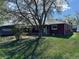 Charming single-Gathering home featuring a brick exterior with an expansive front yard shaded by a mature tree at 1985 Blackhawk St, Aurora, CO 80011