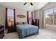 Comfortable bedroom with vaulted ceiling, ceiling fan, and natural light from two bright windows at 10127 Bluffmont Ln, Lone Tree, CO 80124