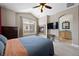 Cozy bedroom featuring a fireplace, flat screen TV, and an arched doorway to an en-suite bathroom at 10127 Bluffmont Ln, Lone Tree, CO 80124