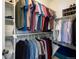 This organized walk-in closet features ample storage space for clothes and accessories, with white shelves at 10127 Bluffmont Ln, Lone Tree, CO 80124