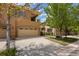 Lovely exterior featuring a two-car garage, a spacious driveway, and tasteful landscaping at 10127 Bluffmont Ln, Lone Tree, CO 80124
