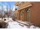 Inviting front entrance with arched doorway, covered porch, and well-maintained landscaping in a stucco home at 10127 Bluffmont Ln, Lone Tree, CO 80124