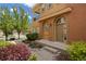 Charming home featuring a tan facade with a decorative arched doorway and inviting curb appeal at 10127 Bluffmont Ln, Lone Tree, CO 80124