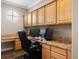 Bright home office with custom cabinets, granite countertops, and updated desk and office equipment at 10127 Bluffmont Ln, Lone Tree, CO 80124