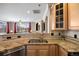 Kitchen area with a granite counter, stainless steel sink, and views into the living area at 10127 Bluffmont Ln, Lone Tree, CO 80124