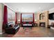 Bright living room with a cozy fireplace, hardwood floors, and a large window with elegant curtains at 10127 Bluffmont Ln, Lone Tree, CO 80124