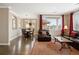 Elegant living room featuring hardwood floors, neutral walls, and comfortable seating arrangement near the dining area at 10127 Bluffmont Ln, Lone Tree, CO 80124