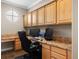 Well-lit office with built-in cabinets, granite countertops, and large work space at 10127 Bluffmont Ln, Lone Tree, CO 80124