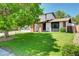 Charming two-story home with manicured lawn, mature tree, and attached two-car garage at 3621 S Kalispell St, Aurora, CO 80013