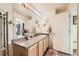 Bright bathroom with neutral tones featuring a vanity with storage and a decorative mirror at 20000 Mitchell Pl # 51, Denver, CO 80249