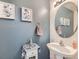 Stylish half bathroom with charming decor, featuring unique wall art and a sleek vanity at 20000 Mitchell Pl # 51, Denver, CO 80249