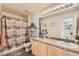 Well-lit bathroom with a shower and tub, featuring decorative plants and a spacious vanity at 20000 Mitchell Pl # 51, Denver, CO 80249