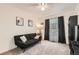 A bedroom featuring carpet, a sofa, and a large window with decorative drapes at 20000 Mitchell Pl # 51, Denver, CO 80249