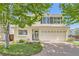 Charming two-story home featuring a brick driveway, a two-car garage and neutral toned siding at 20000 Mitchell Pl # 51, Denver, CO 80249