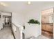 Upstairs hallway featuring carpet, a plant on the half wall and a view of the bathroom at 20000 Mitchell Pl # 51, Denver, CO 80249