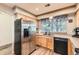 Bright kitchen featuring light wood cabinets, stainless steel appliances, and a stainless steel refrigerator at 20000 Mitchell Pl # 51, Denver, CO 80249