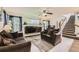 Bright living room features modern furnishings, hardwood-style floors, a fireplace, and staircase at 20000 Mitchell Pl # 51, Denver, CO 80249