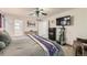 The main bedroom showcasing a large bed, TV, dresser, and access to the en-suite bathroom at 20000 Mitchell Pl # 51, Denver, CO 80249
