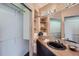 Charming bathroom featuring built-in shelves, stylish lighting, and a sleek black sink and countertop at 3001 Eagle Ridge Rd, Longmont, CO 80503