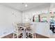 Comfortable dining area with wood floors and light-colored walls, plus a view into the living room at 3067 S Holly Pl, Denver, CO 80222