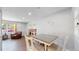 Cozy dining space featuring wood-style floors, bright white walls, and an adjacent living area at 3067 S Holly Pl, Denver, CO 80222