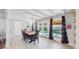 Dining room featuring white wood trim, neutral colors, and a view of the fenced backyard at 3067 S Holly Pl, Denver, CO 80222