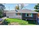 Exterior view showcasing a well-maintained home with a lush lawn and two-car garage at 3067 S Holly Pl, Denver, CO 80222