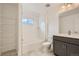 Bathroom features a shower over tub, vanity with double sinks, and tile flooring at 6926 Kendrick Ln, Arvada, CO 80007