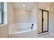 Modern bathroom features a soaking tub and separate glass-enclosed shower at 6926 Kendrick Ln, Arvada, CO 80007