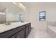 Bathroom featuring double sinks, marble floors, and modern fixtures at 6926 Kendrick Ln, Arvada, CO 80007