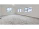 Large, bright bedroom with ample natural light and neutral carpeting at 6926 Kendrick Ln, Arvada, CO 80007