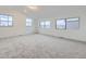 Large, sunny bedroom showcases several windows and neutral carpet at 6926 Kendrick Ln, Arvada, CO 80007
