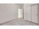 Bright bedroom features plush carpeting and a closet with sliding doors at 6926 Kendrick Ln, Arvada, CO 80007