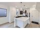 Modern kitchen featuring a large island, stainless steel appliances, and pendant lighting at 6926 Kendrick Ln, Arvada, CO 80007