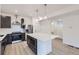 Modern kitchen with stainless steel appliances, an island and dark cabinetry at 6926 Kendrick Ln, Arvada, CO 80007