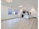 Bright open-concept living room and kitchen with hardwood floors and large windows at 6926 Kendrick Ln, Arvada, CO 80007