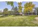 Grassy backyard featuring mature trees, patio and second story deck at 7360 S Owens Ct, Littleton, CO 80127