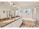 Elegant bathroom featuring double sinks, granite countertops, soaking tub and glass shower at 7360 S Owens Ct, Littleton, CO 80127