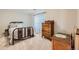 Charming bedroom featuring a decorative metal bed frame and vintage wood dresser at 7360 S Owens Ct, Littleton, CO 80127