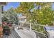 Inviting deck area with comfortable seating overlooking mature trees and landscaping at 7360 S Owens Ct, Littleton, CO 80127